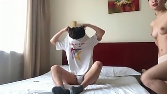A Pair Of Chinese Lovers Engage In Passionate Intimacy In A Hotel Room